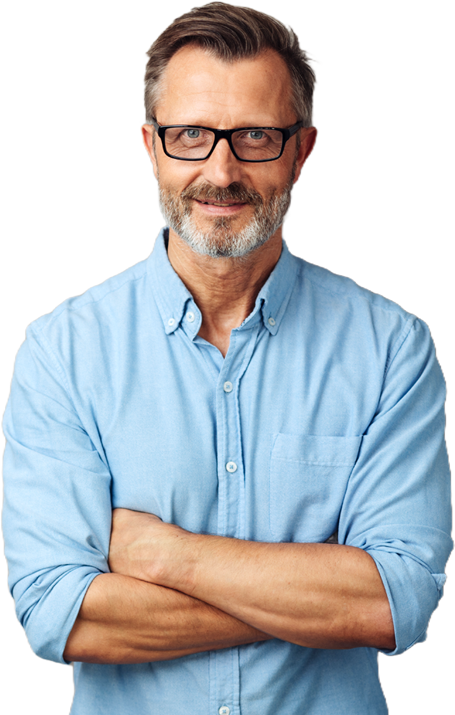 Handsome middle-aged man with grey beard, wearing glasses and a blue shirt, standing with arms crossed and looking at camera smiling